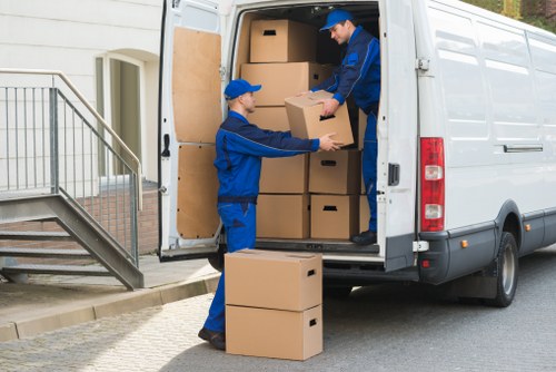 Moving team loading boxes and furniture for a Kennington Movers service