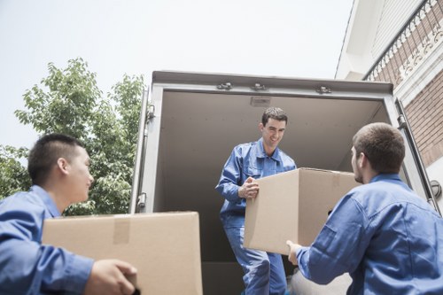 Local movers handling boxes and furniture in a Kennington flat