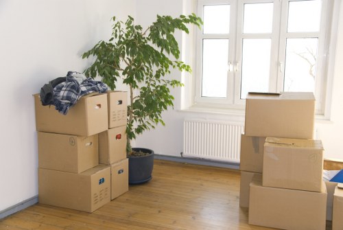 Furniture, boxes, and moving equipment prepared for a Kennington removal truck